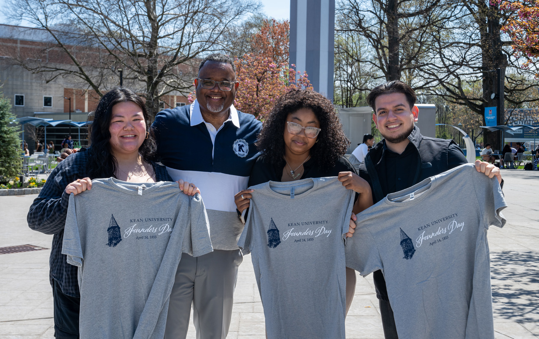 Students holding t-shirts