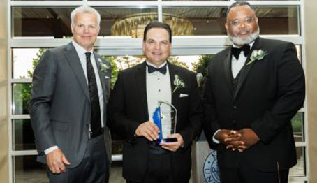 New Jersey Senate President Nicholas P. Scutari '89 (center) poses for a photo with Kean Board of Trustees Chair Steve Fastook ’06H (left) and Kean President Lamont O. Repollet, Ed.D., '00 (right) after receiving Kean's William Livingston Award at the gala.